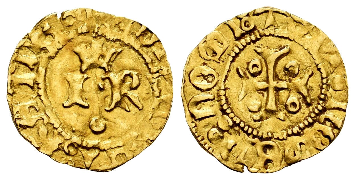 A close-up of a gold coinDescription automatically generated